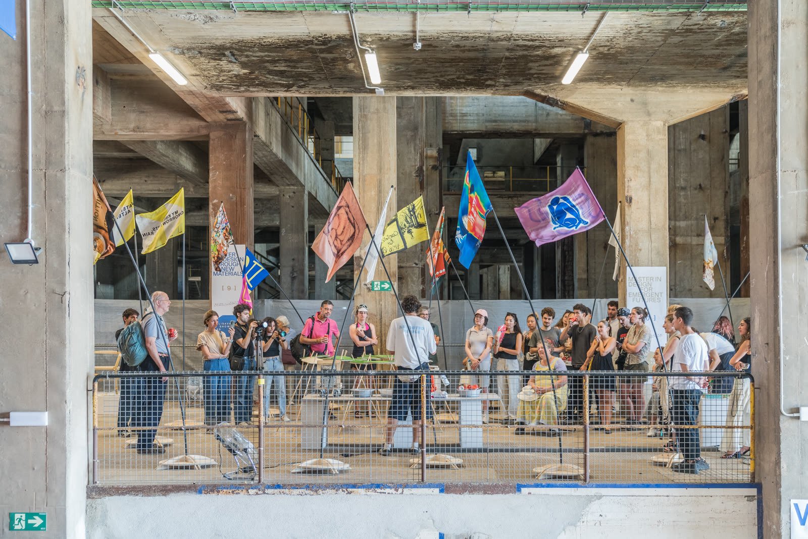 An exhibition under flags in an industrial hall