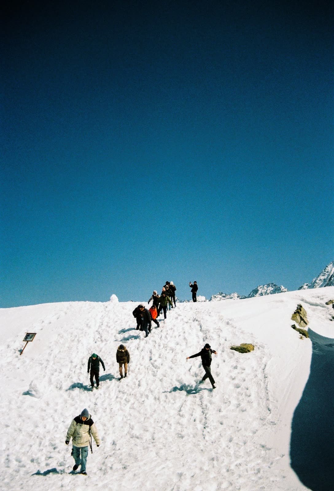 Walking down a snow ridge in the mountains