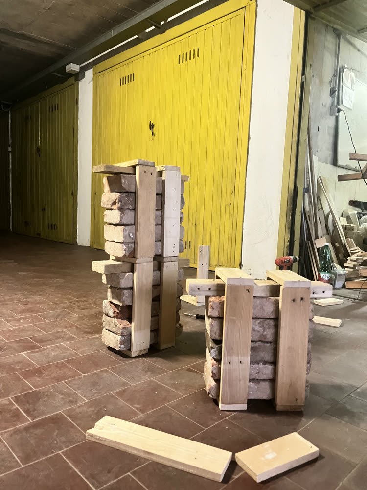 Standing next to the first finished stools, garage doors behind