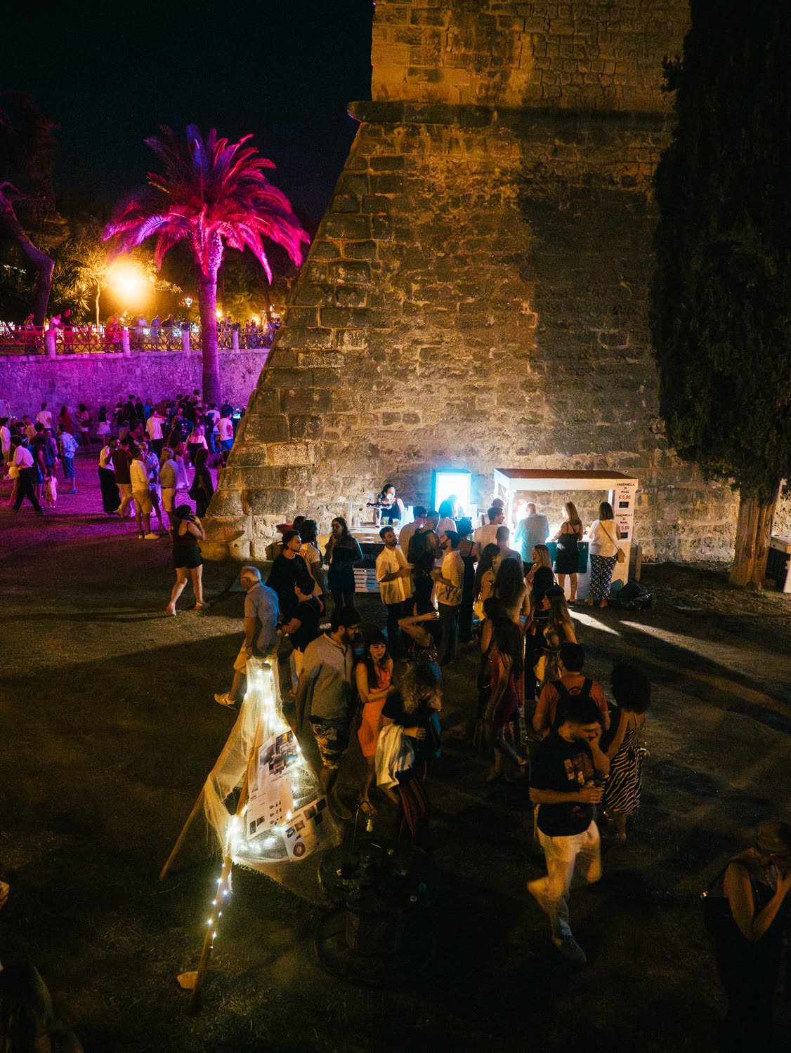 The crowd gathered under the fortress ramp