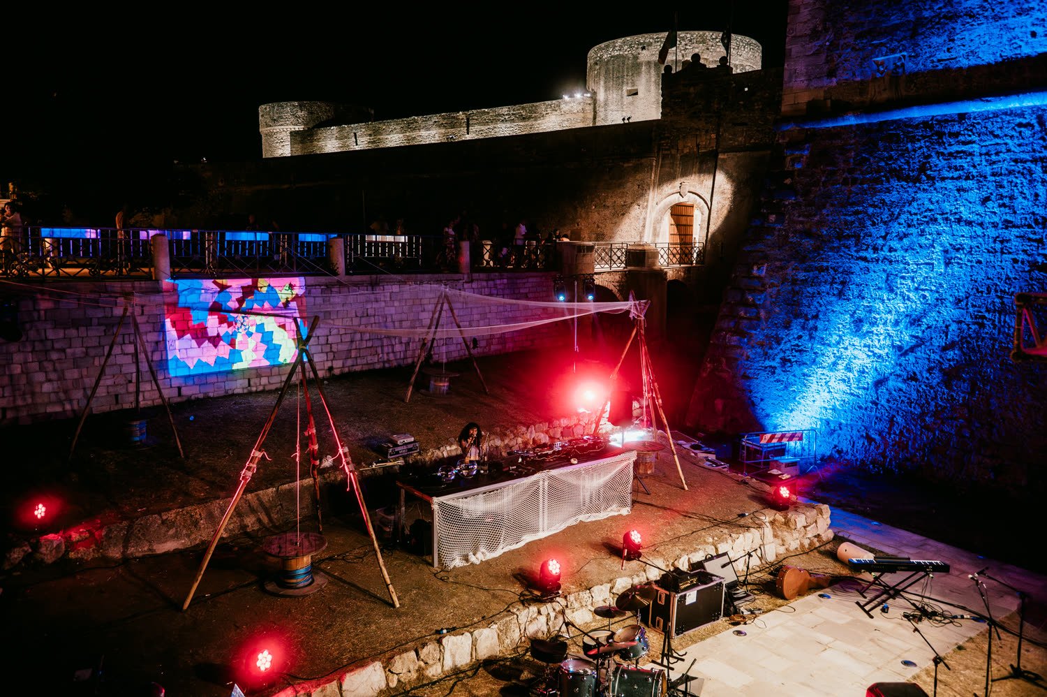 The wall of the fortress washed in blue and red light