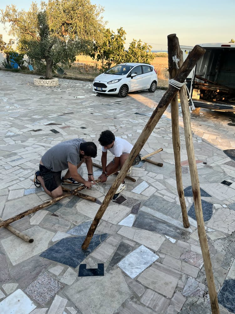 A tripod taking shape beside the van