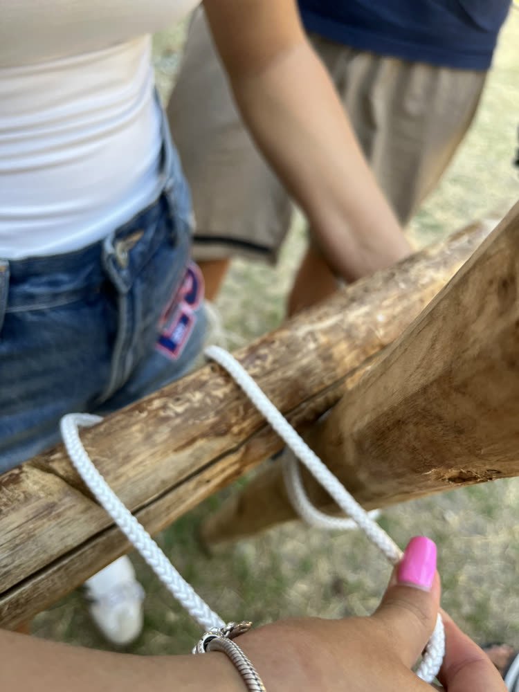 Rope pulled tight around a pole, the scouts' knot