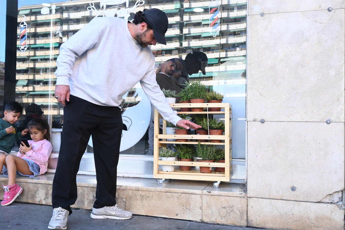 A shelf in the plaza, beside the panel explaining the project